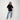 Woman wearing a black t-shirt and blue jeans on a white background