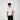 Man wearing a white t-shirt with a small black logo on a white background