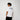 Man wearing a white t-shirt with 'JEREMIAD' printed on the back against a white background